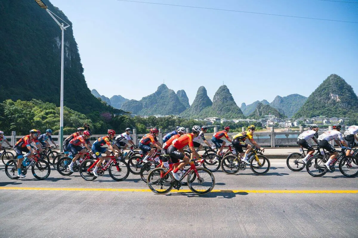 Cyclist riding through karst mountain scenery in Yangshuo, China