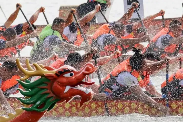 Dragon boats racing on a river during the Dragon Boat Festival in China