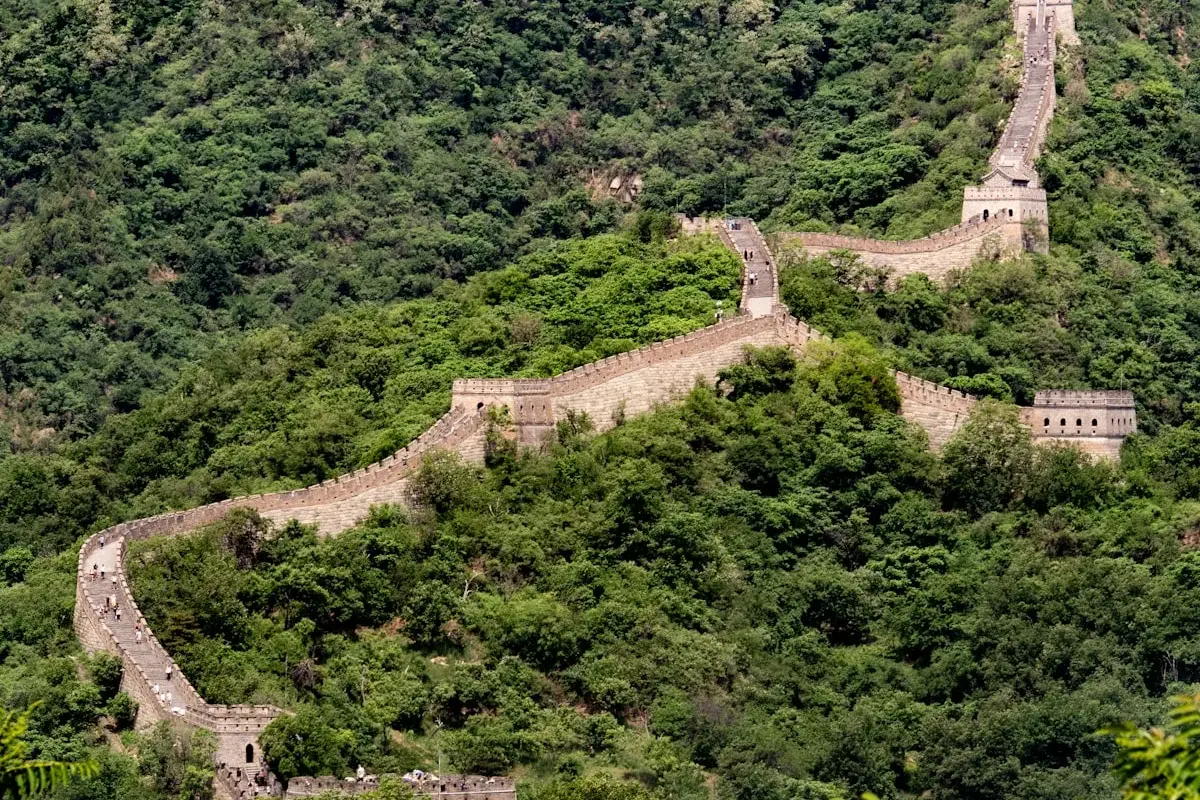 Great Wall of China winding through mountain ridges at golden hour