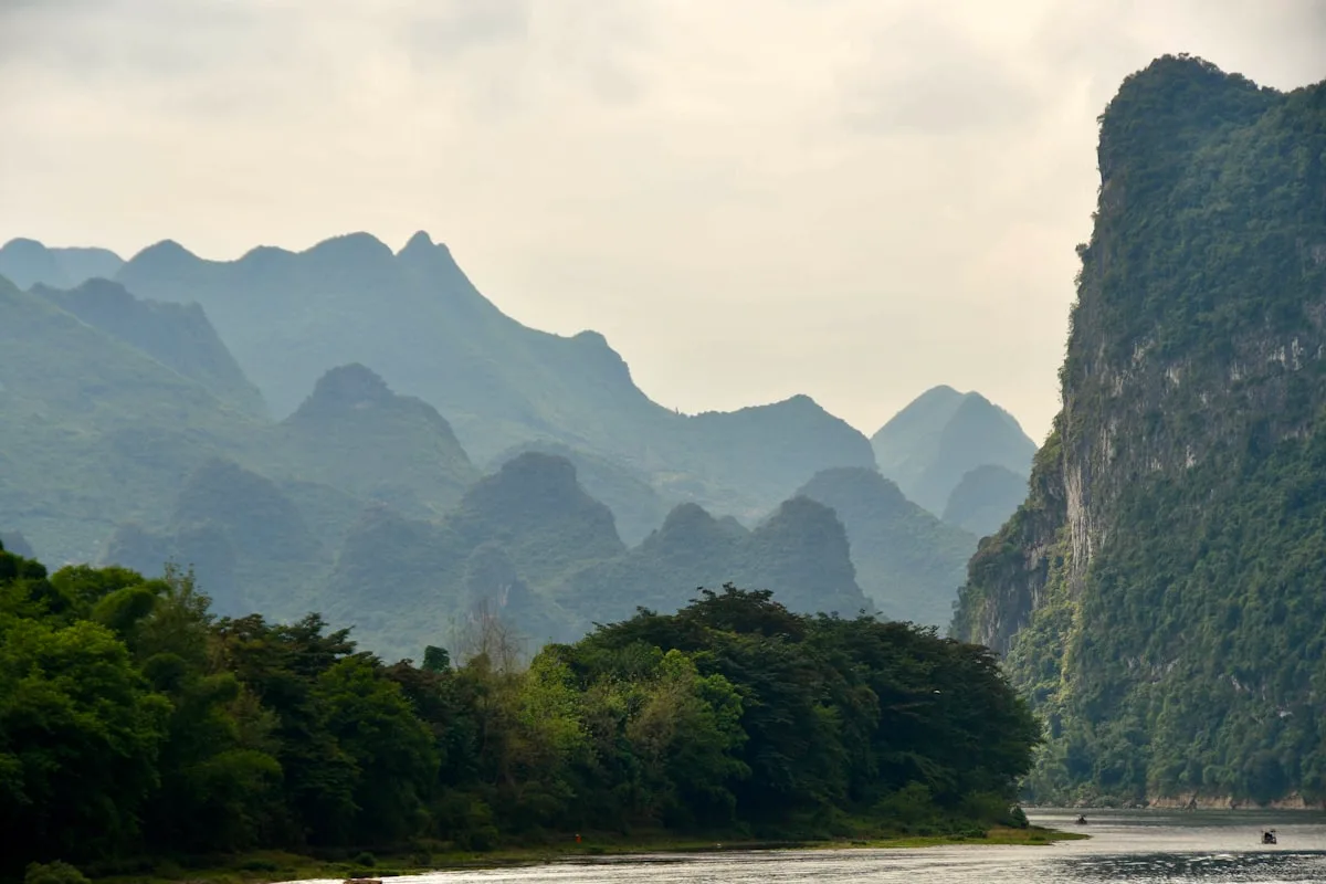 Karst peaks rising above lush green hills near the Li River in Guilin, China