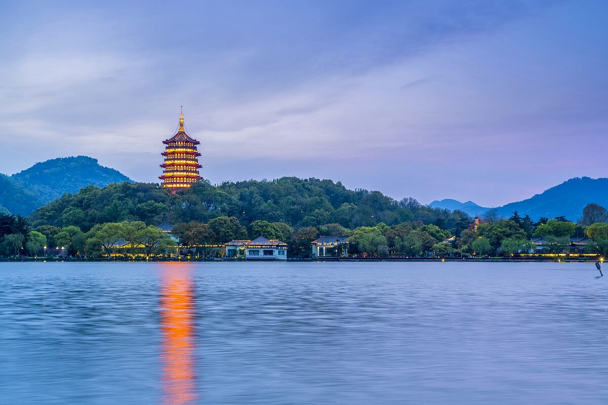 West Lake in Hangzhou with traditional pavilion and lush green hills