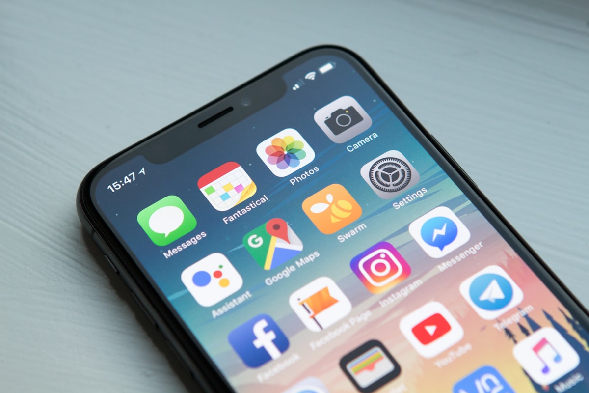 Smartphone with various travel apps on screen