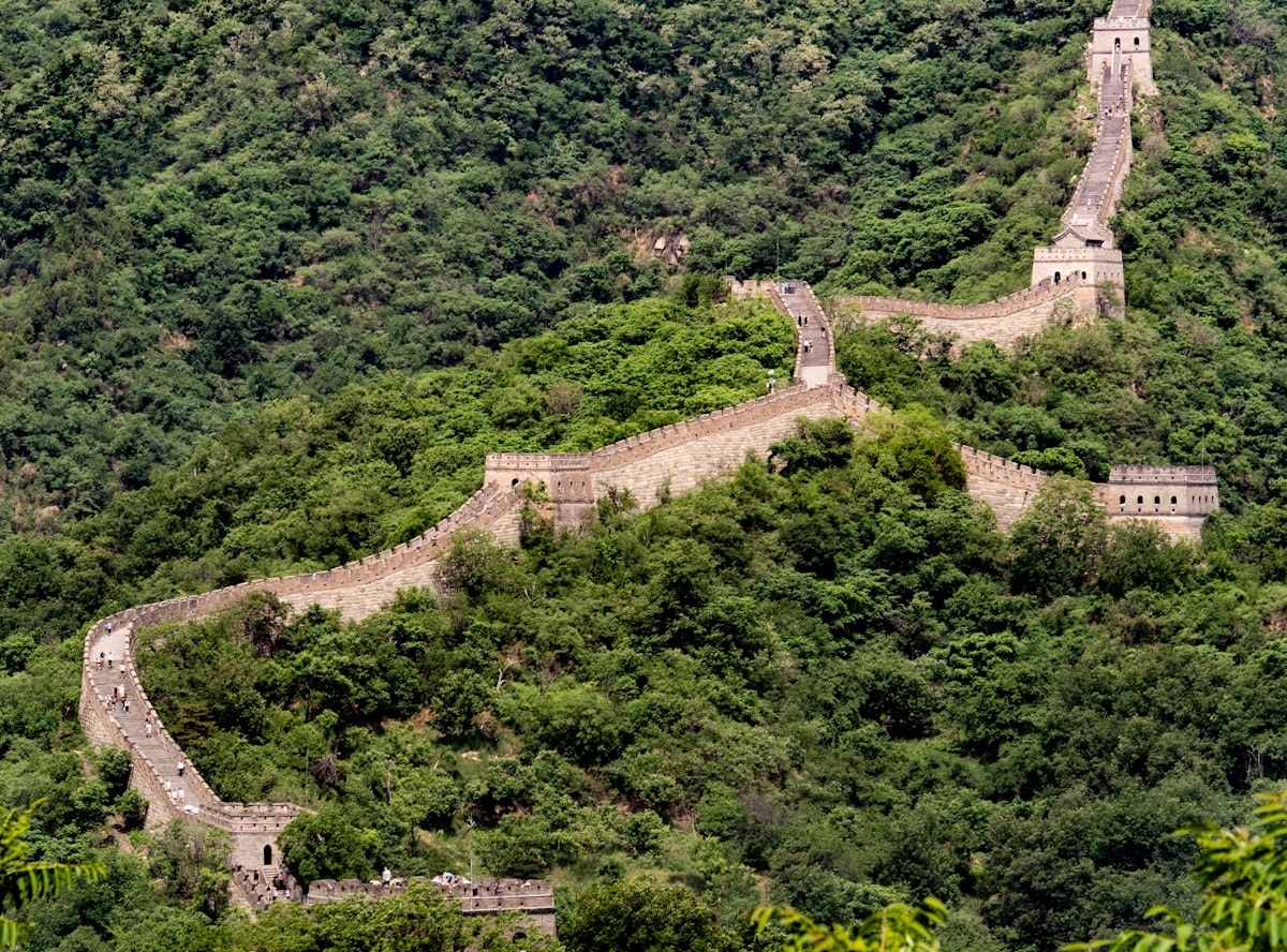 Great Wall of China winding through mountain ridges at golden hour