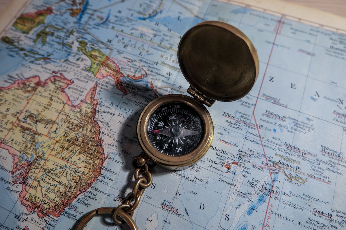 Brass compass resting on a travel map — planning a trip to China