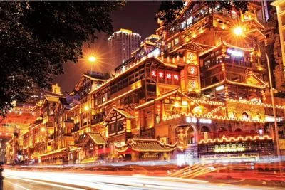 Chongqing Hongyadong at night with glowing lights and riverside view