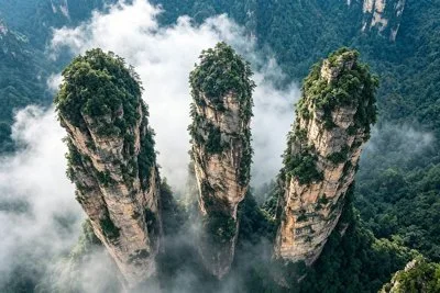 Zhangjiajie sandstone pillars rising through mist