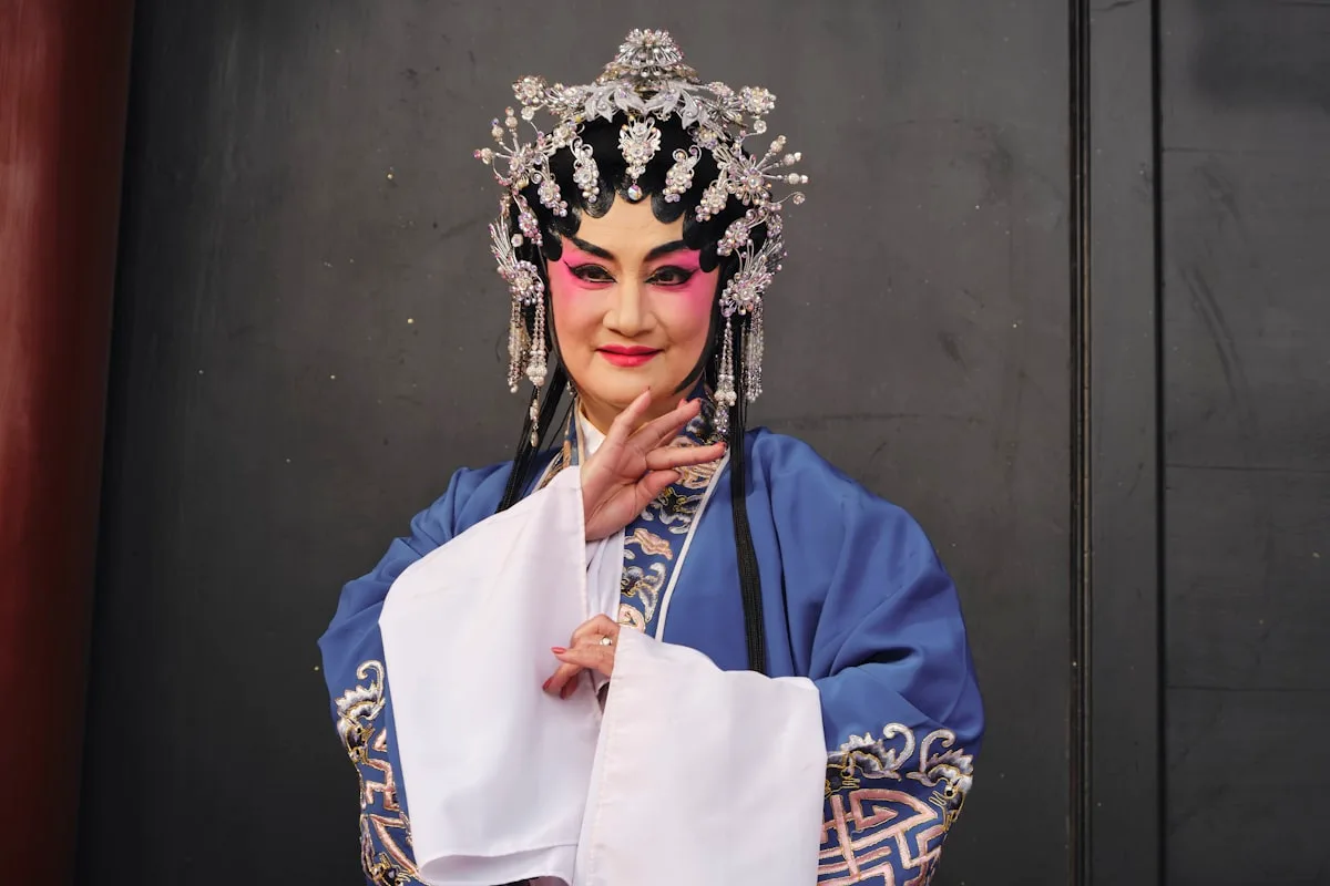 a woman dressed in a chinese costume poses for a picture