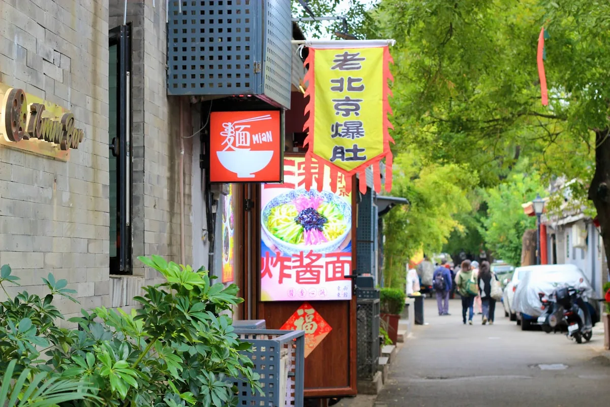 Street with signs for noodles and food