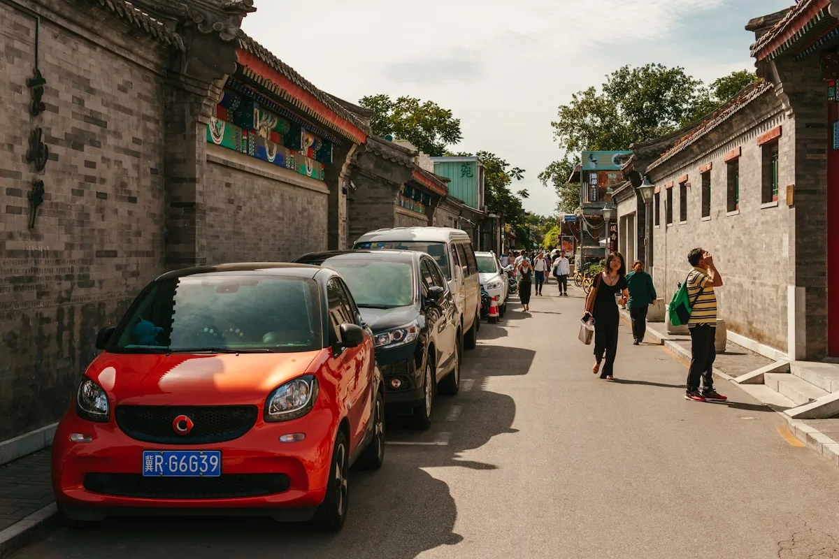 A red car parked on the side of a road