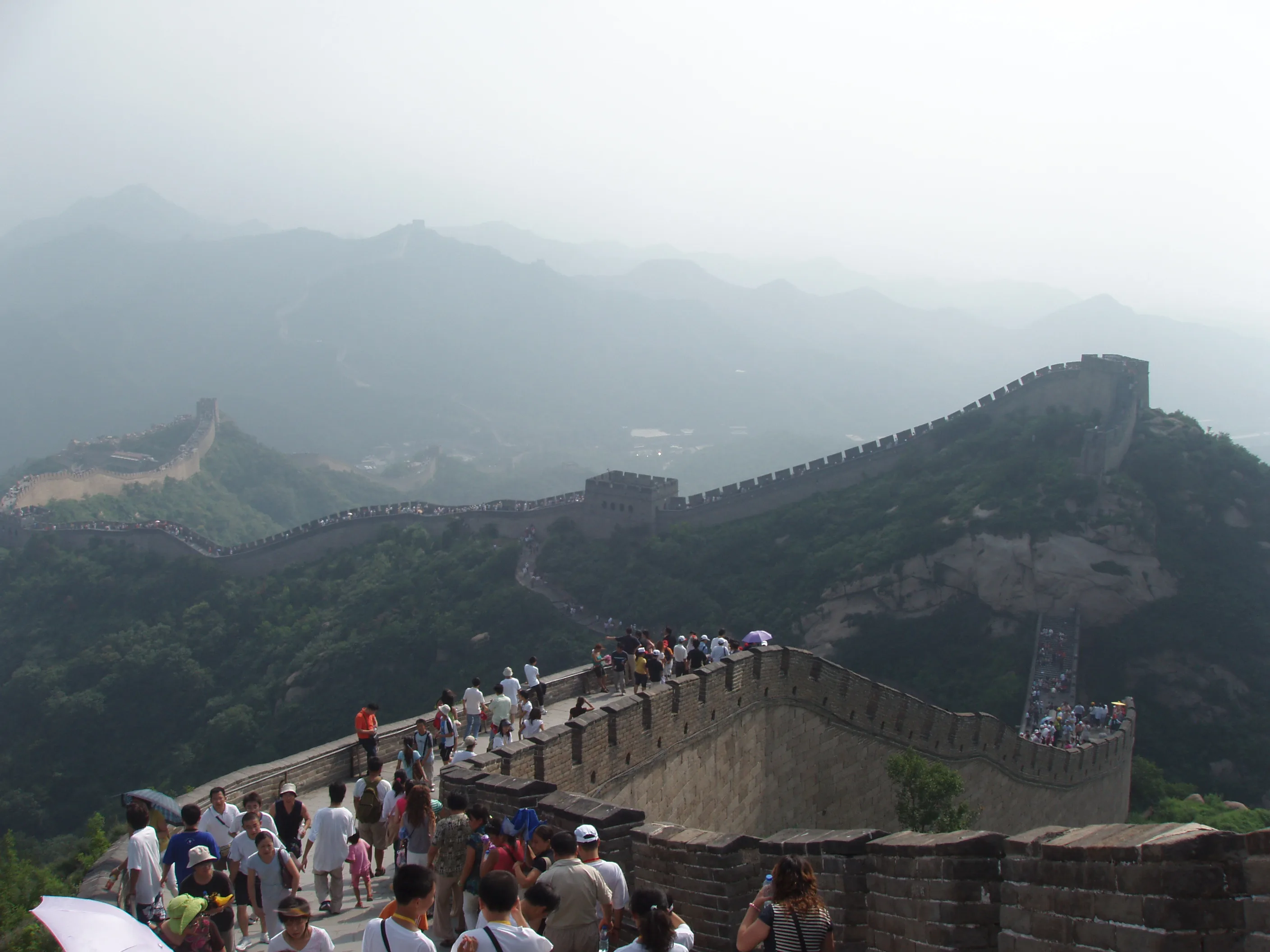 Tourists walking the Badaling section of the Great Wall above layered hills (Photo: Dquai via Wikimedia Commons)