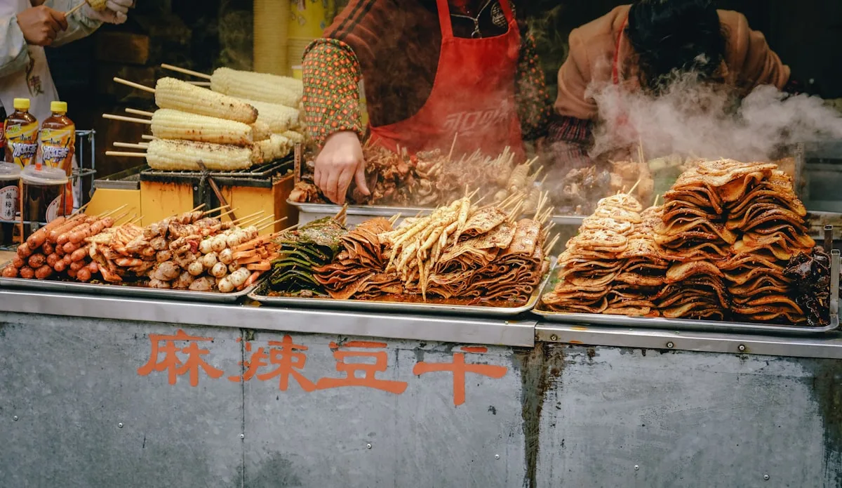A Chinese street food stall cooking spicy tofu skewers, steam rising