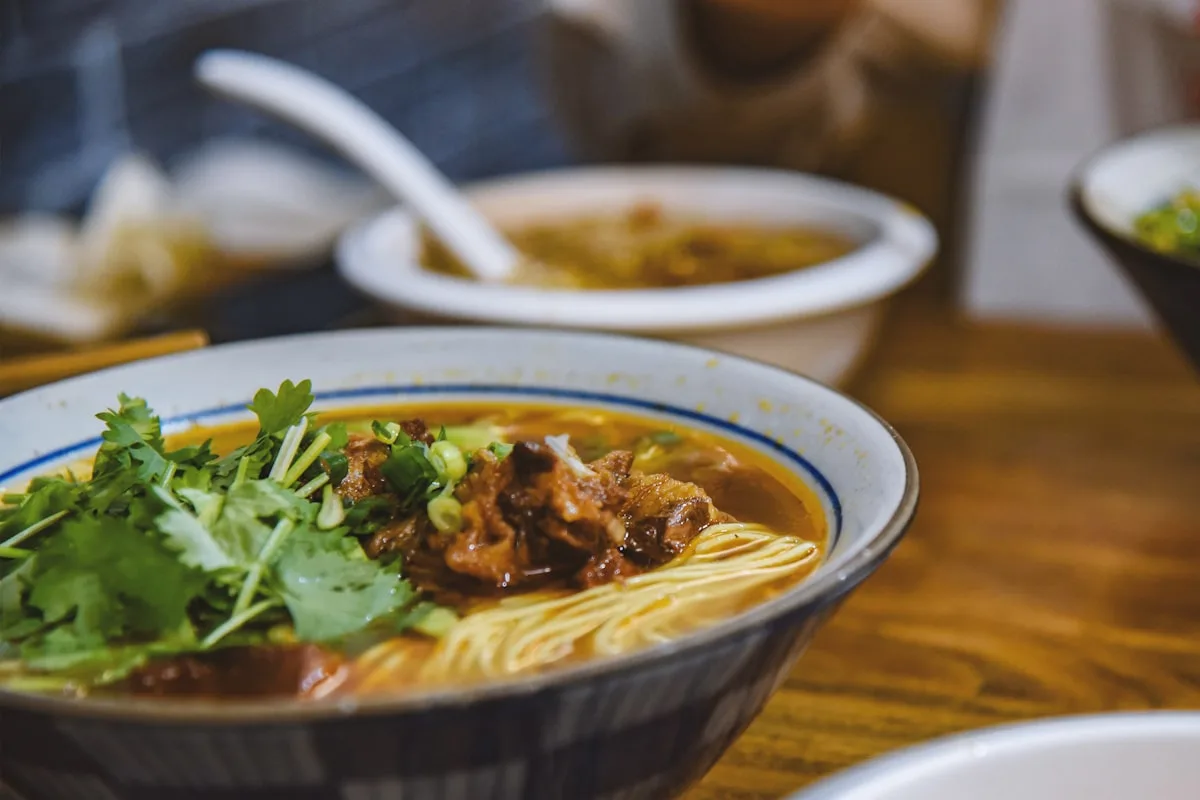 A bowl of Chongqing-style spicy beef noodles in red chili oil