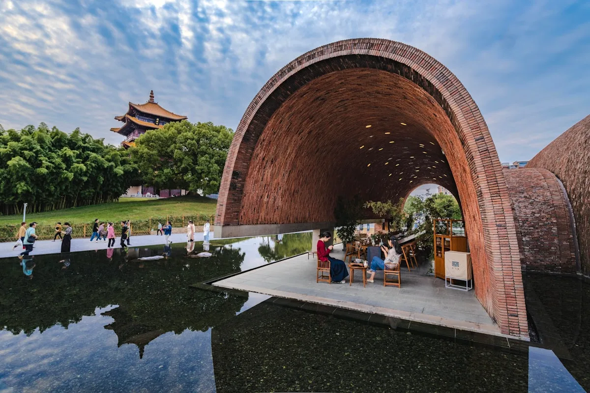 a group of people sitting at a table under a bridge