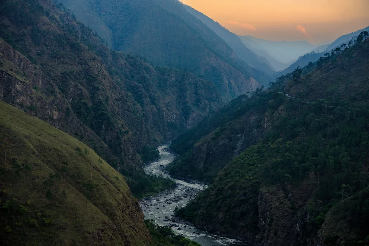A winding river flows through a majestic mountain valley.