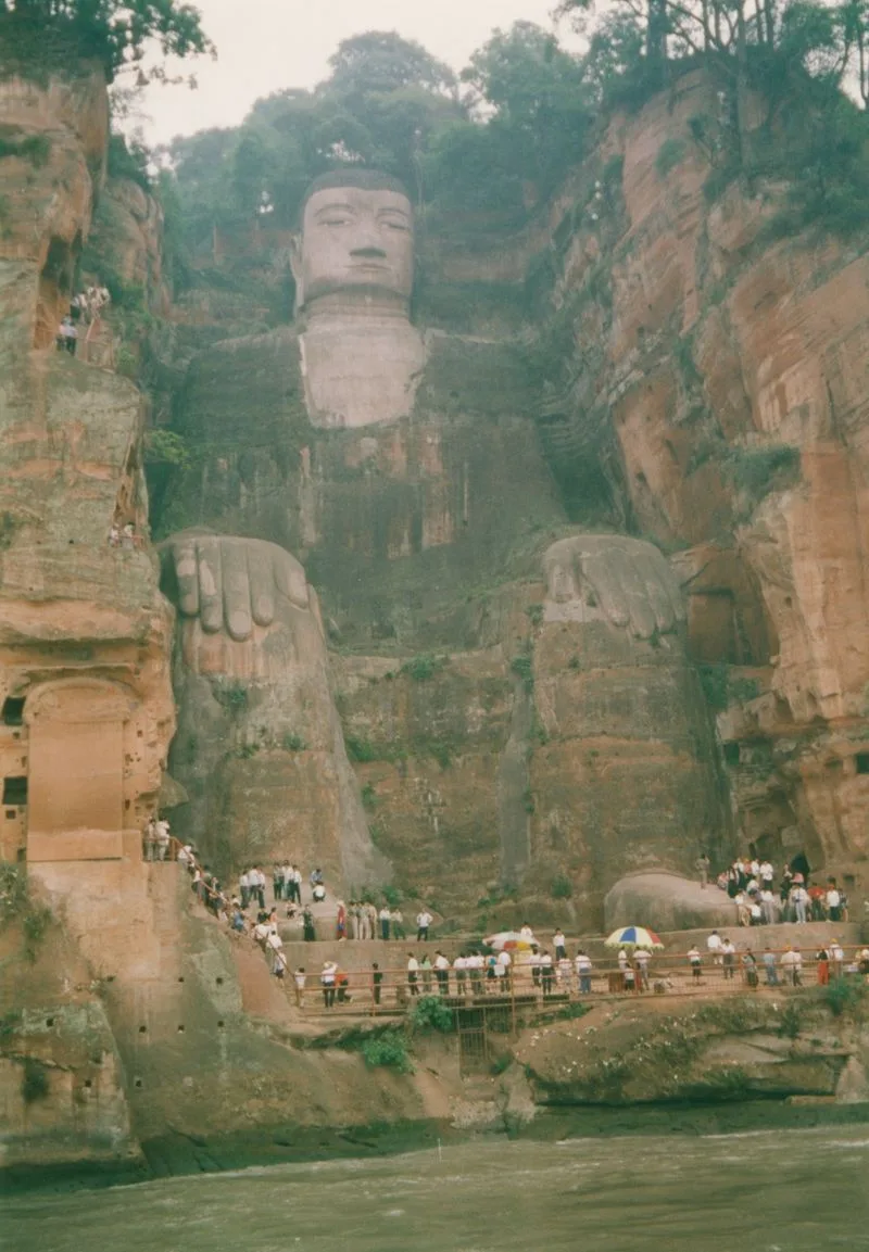 The Leshan Giant Buddha, a 71-meter seated Maitreya carved into red sandstone, towering above the river confluence