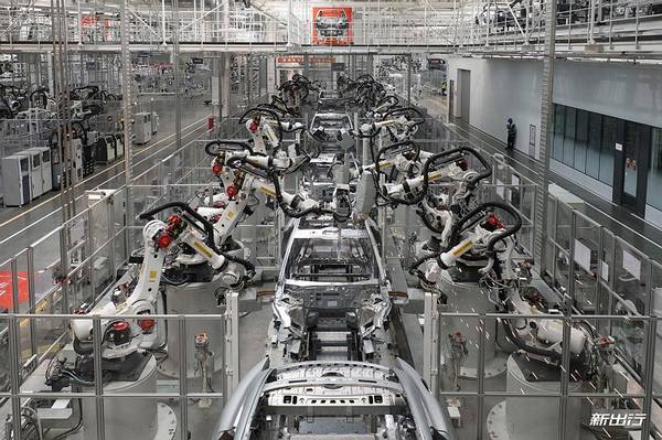 Electric shuttle touring visitors through Xiaomi's automated production workshop in Beijing