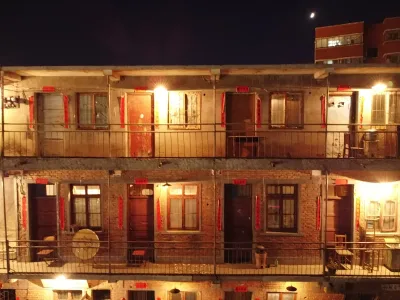 An older residential building with red couplets and warm lights