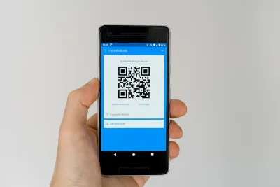 A phone showing an Alipay QR code to receive payment
