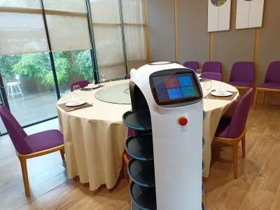 A food delivery robot at a restaurant table in China
