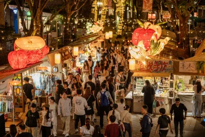 A bustling Chinese night market with lanterns and stalls