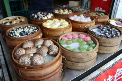 A street stall in China with bamboo steamers full of shaped buns