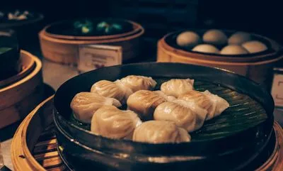 Chinese dumplings steaming in a bamboo steamer — in-depth food and travel guides