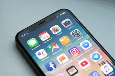 Smartphone with various travel apps on screen