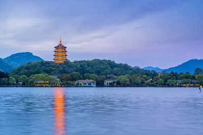 West Lake in Hangzhou with traditional pavilion and lush green hills