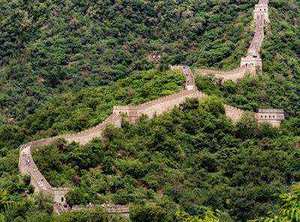 Great Wall of China winding through mountain ridges at golden hour
