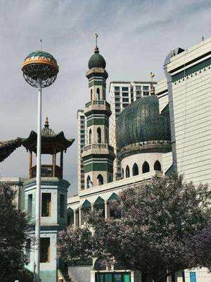 Green and white concrete dome of a mosque in China under blue sky