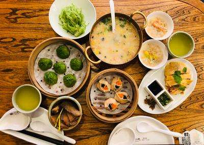 A lively spread of Chinese dishes — dumplings, noodles, stir-fries, and soups representing the diversity of China's Eight Great Cuisines