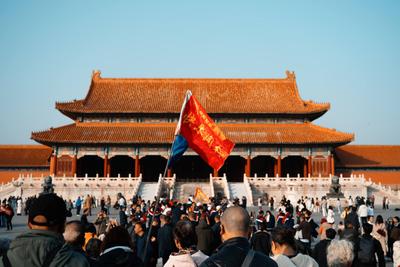 Crowd gathered in front of a large traditional Chinese building during Golden Week