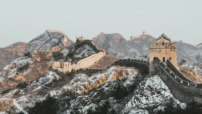The Great Wall of China winding along a snowy mountain ridge