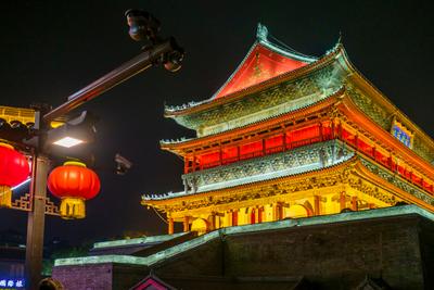 Ancient Chinese building lit up with red lanterns at night in Xi'an